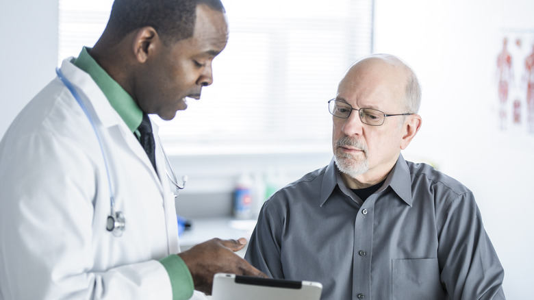 man having consultation with doctor in office