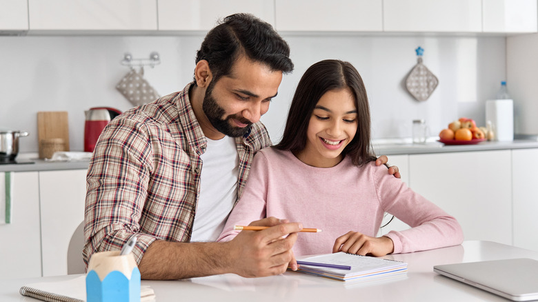 Dad helping daughter with homework