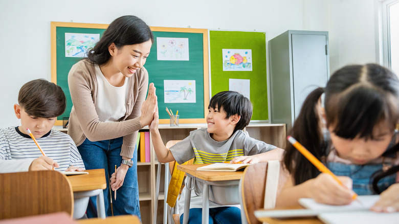 Teacher and student giving high-five