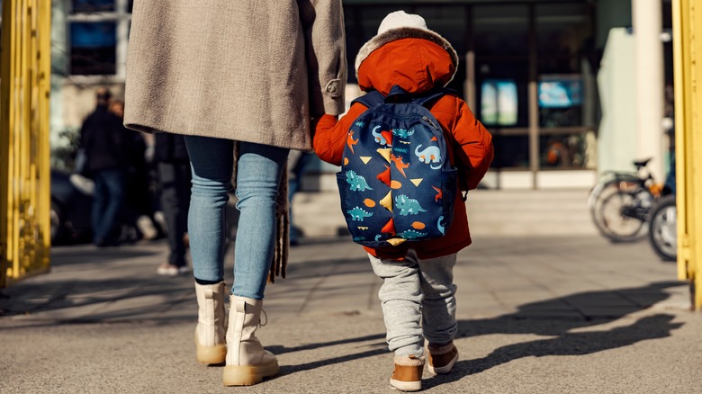 Parent holding student's hand