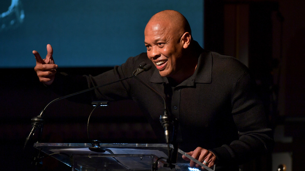 Dr. Dre speaks at a podium