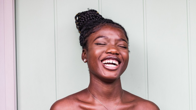 Woman with braided topknot smiling