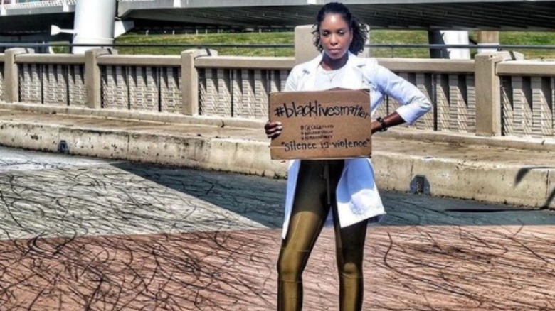 Dr. Shepherd outside holding a Black Lives Matter sign