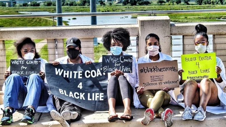 A group of Black doctors, including Dr. Jessica Shepherd, at a Black Lives Matter protest holding signs