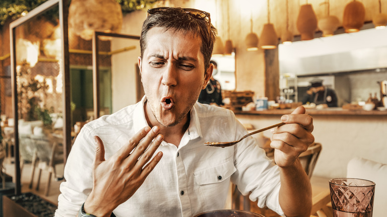 man eating spicy food