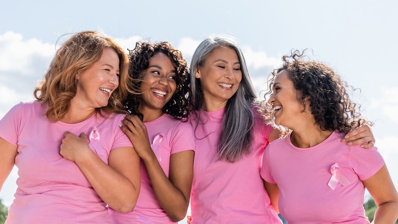 Group of women wearing breast cancer awareness ribbons