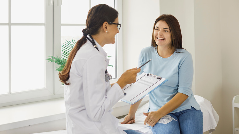 Doctor talking to a female patient, both smiling