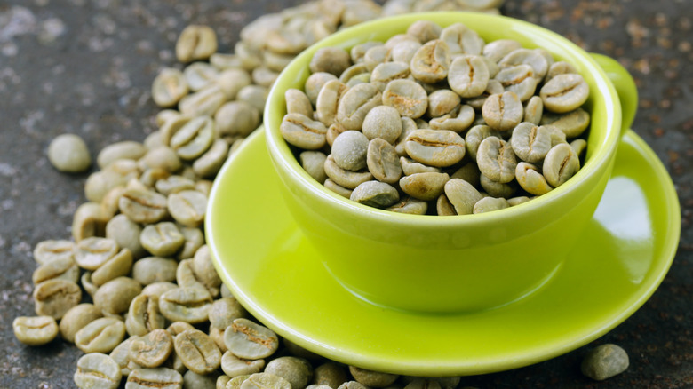 Green coffee beans in a green mug