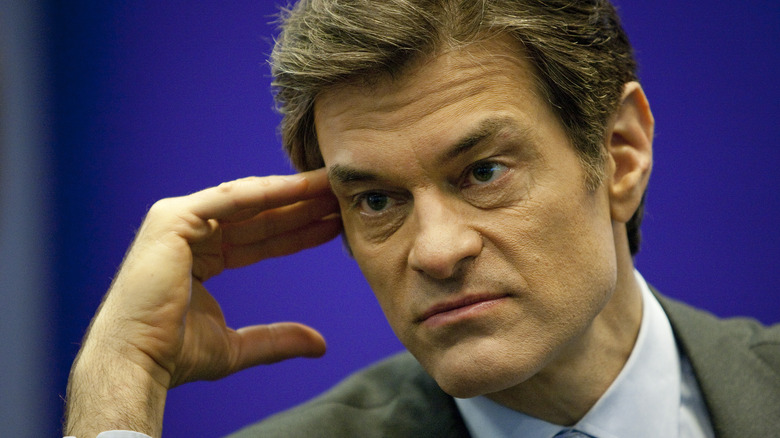 Close-up of Dr. Oz leaning his head on his hand