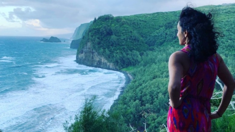 Priyanka Wali stands on a cliff overlooking the ocean