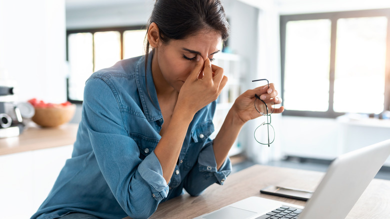 anxious and tired woman working from home during pandemic