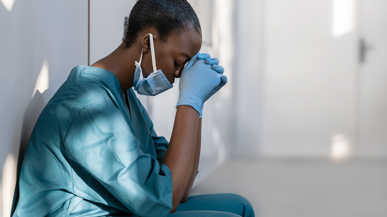 tired and depressed african female healthcare staff