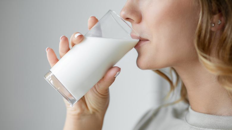 woman drinking a glass of milk