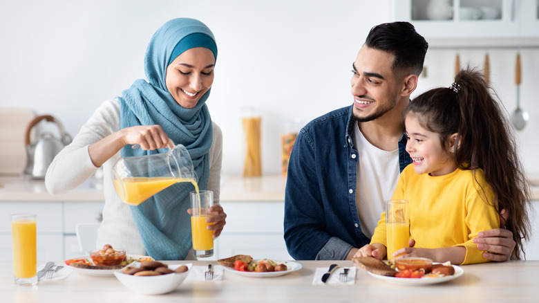 Family drinking orange juice