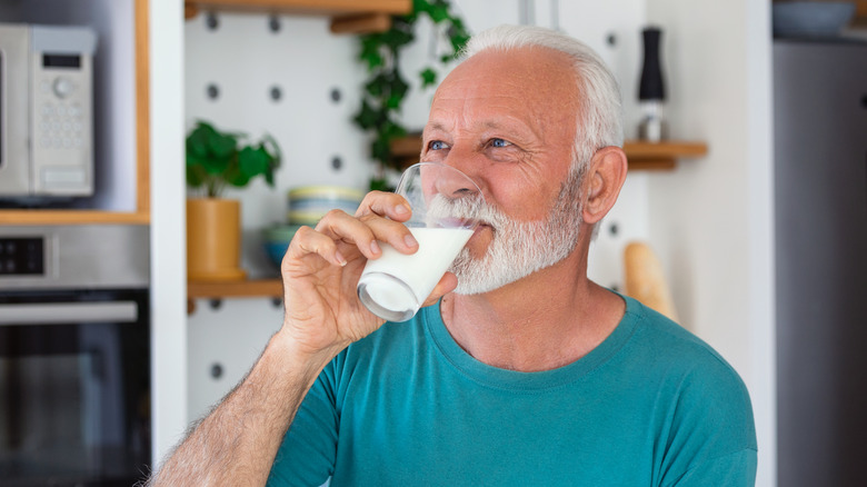 older man drinking milk