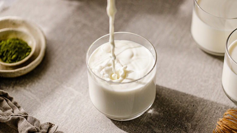 milk being poured into a glass