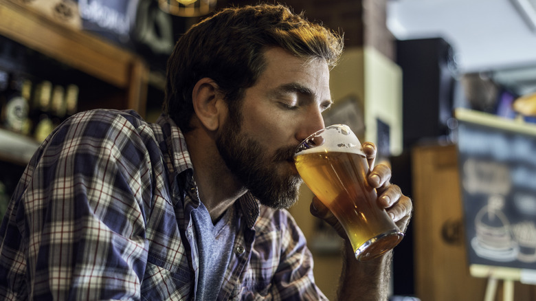 A man enjoying a pint of beer in a bar