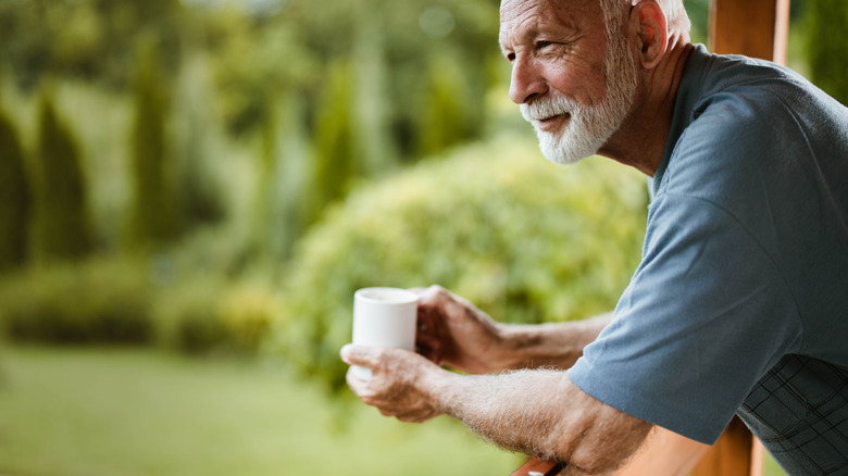 Man drinking coffee outdoors