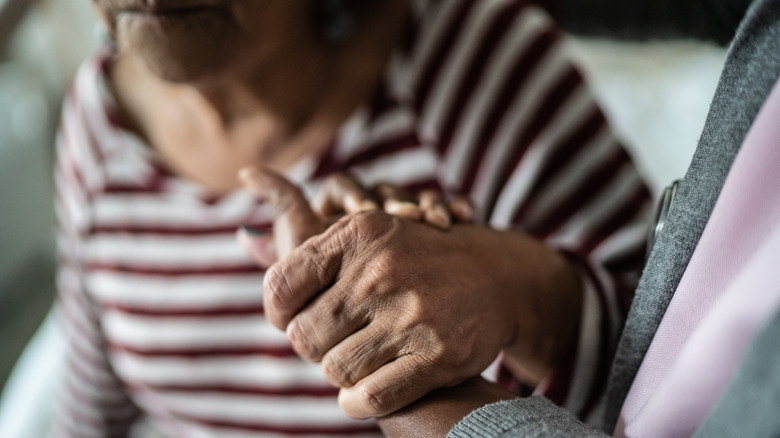 Elderly women holding hands