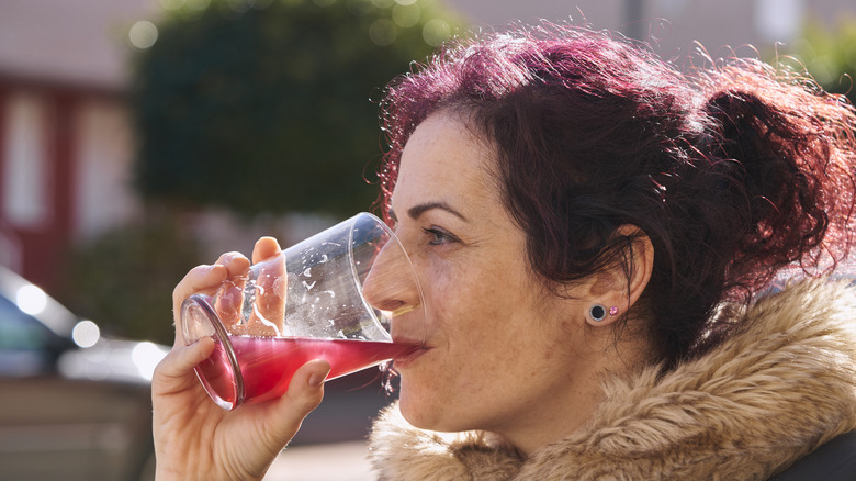 woman drinking cranberry juice