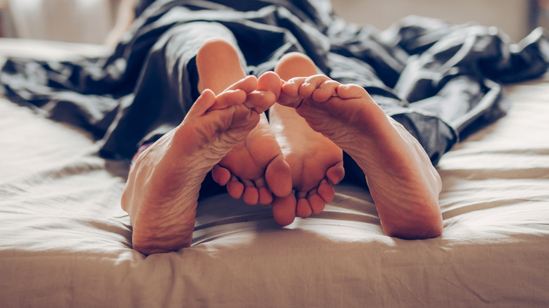 Couple's feet hinting at sex