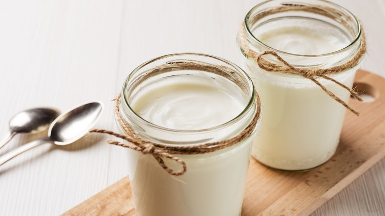 Two glass jars of Greek yogurt