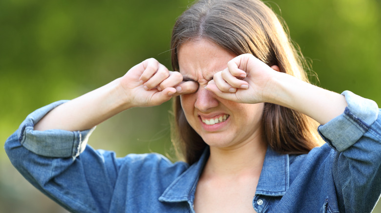 Woman rubbing eyes