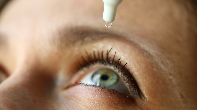 Woman using eyedrops