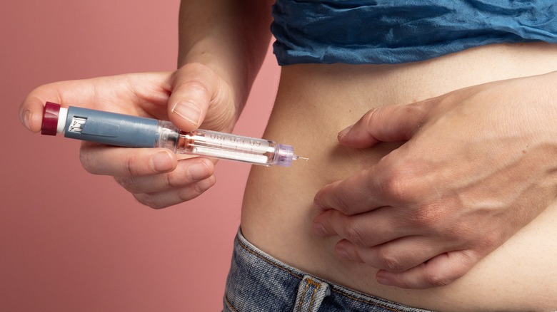 Diabetic woman injecting insulin