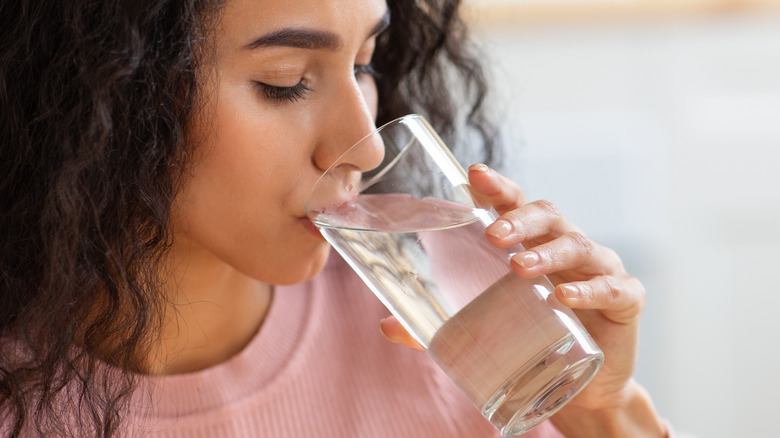 Woman hydrating with water