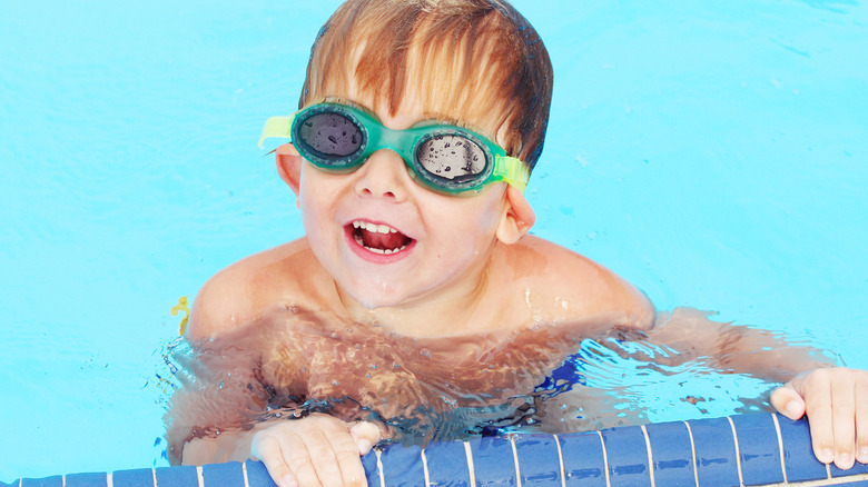 Little boy in goggles looking up 