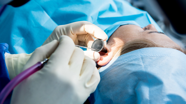 Woman's ear being operated on