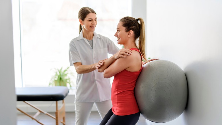 physiotherapist supervising exercise session