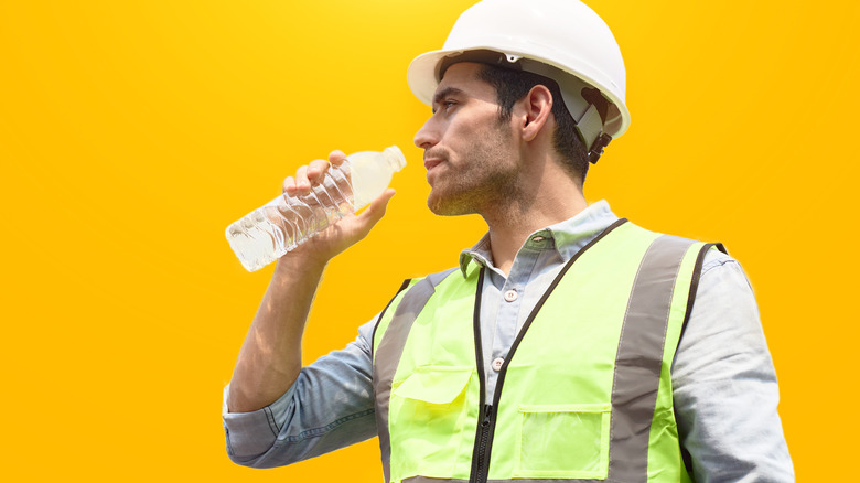 construction worker drinking water