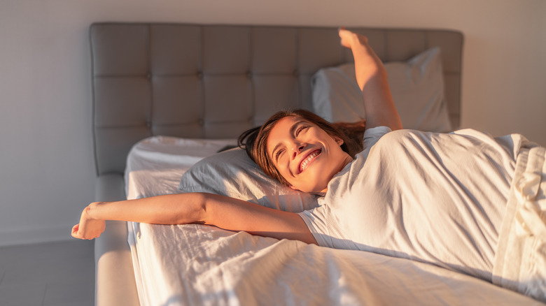 woman waking up with sunshine