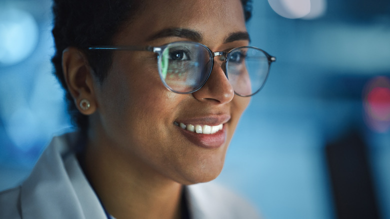 woman with glasses looking at screen