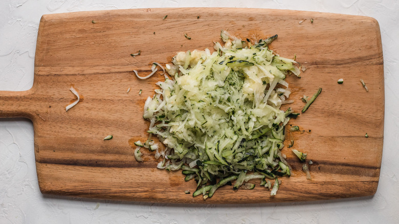 grated zucchini on a cutting board 