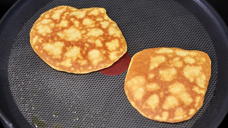 Browned pancakes flipped on a large pan