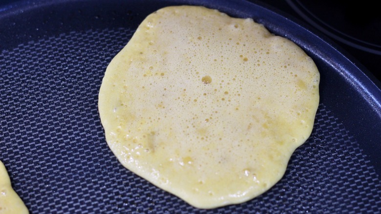 Small bubbles forming on pancake batter on pan