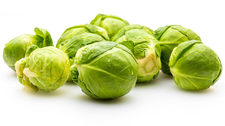 Close up of raw Brussels sprouts against a white background