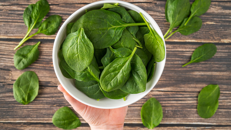 fresh spinach in white bowl