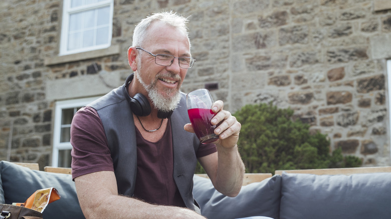 older man drinking beetroot juice