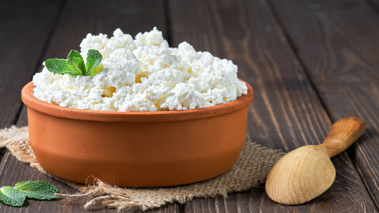 bowl of farmer's cheese and a wooden spoon