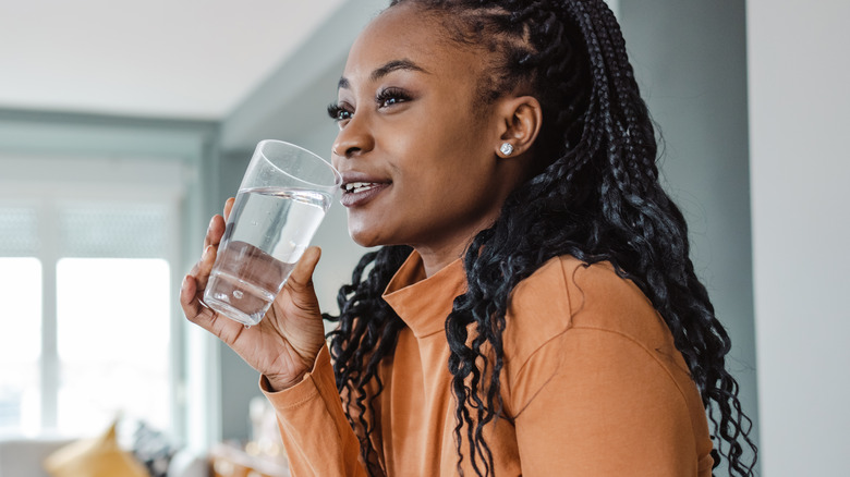 smiling woman drinking water