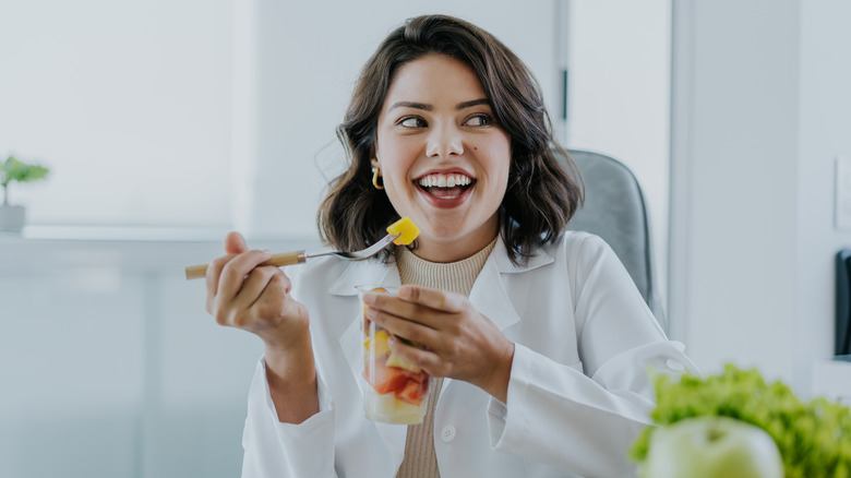 woman eating a fruit salad