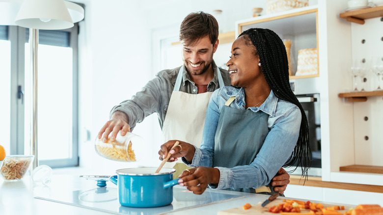 couple fixing healthy dinner