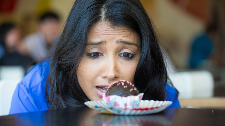 Woman craving chocolate cupcake