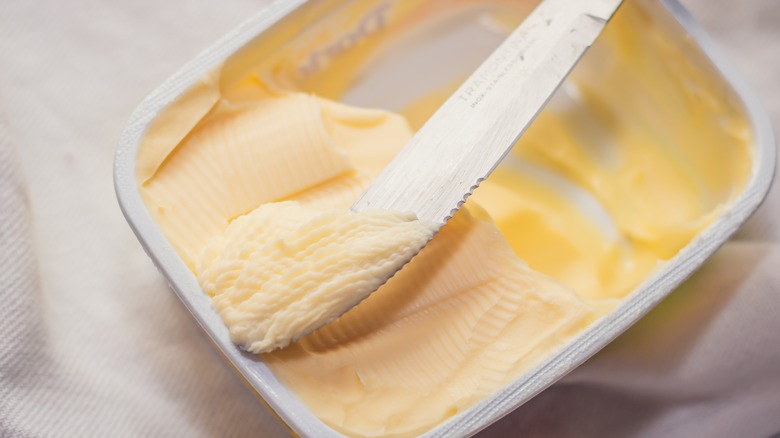 Knife in tub of margarine