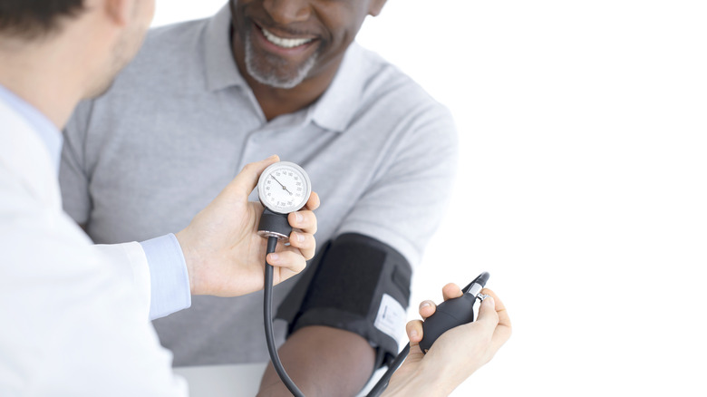 man getting his blood pressure checked