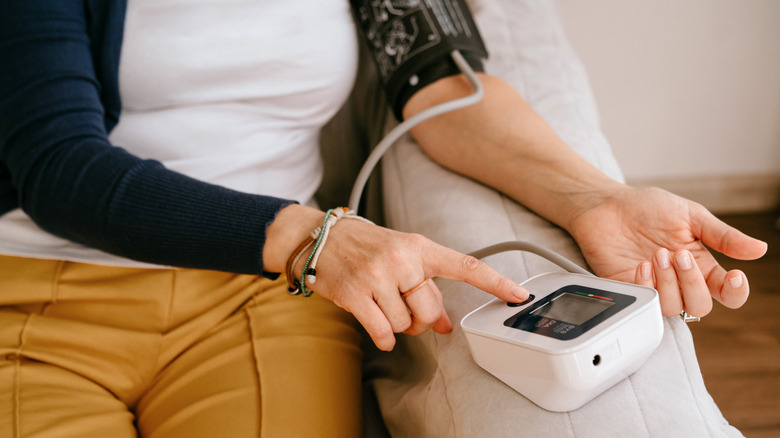 woman checking blood pressure at home